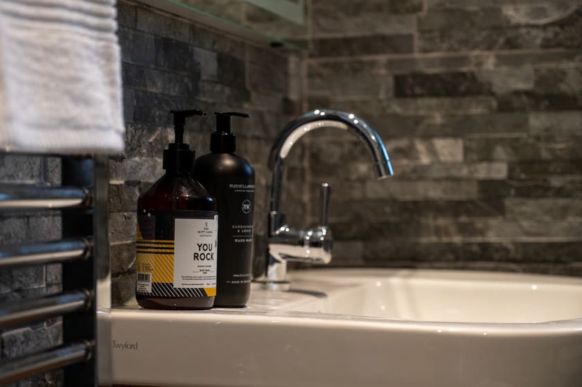 Shower room with luxury toiletries and slate tiles