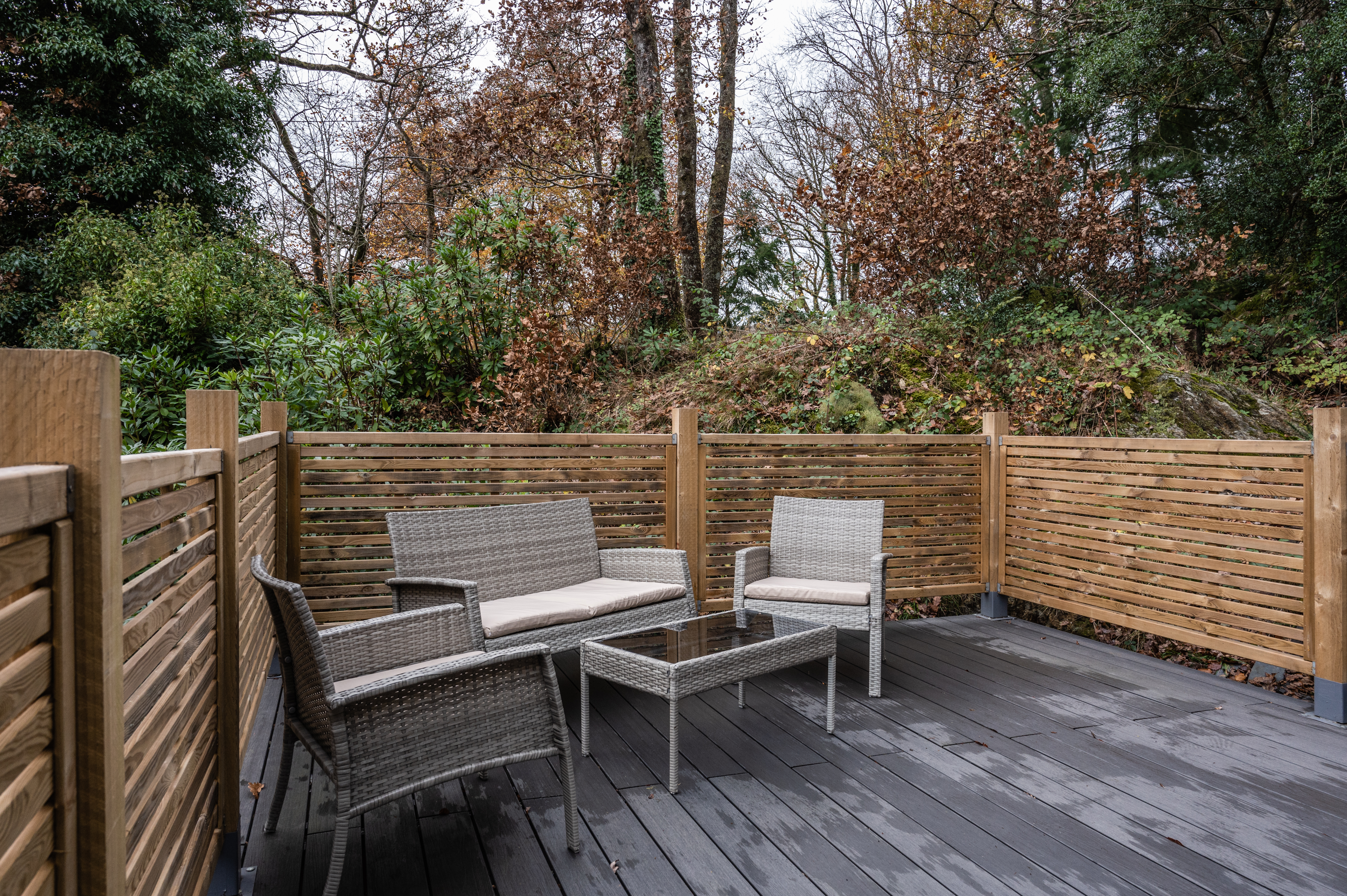 Private mountain deck with seating surrounded by trees