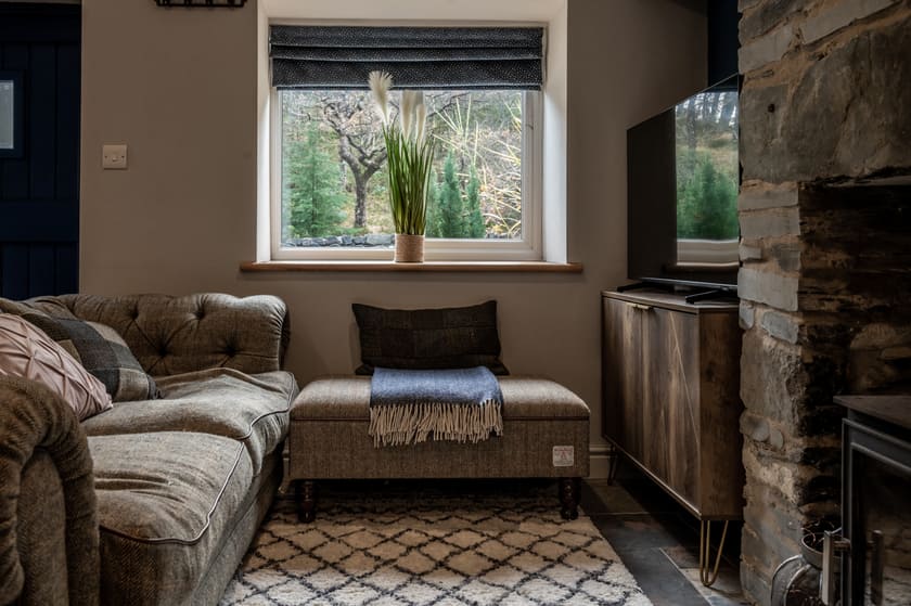 Harris Tweed sofa with wool blankets and window view