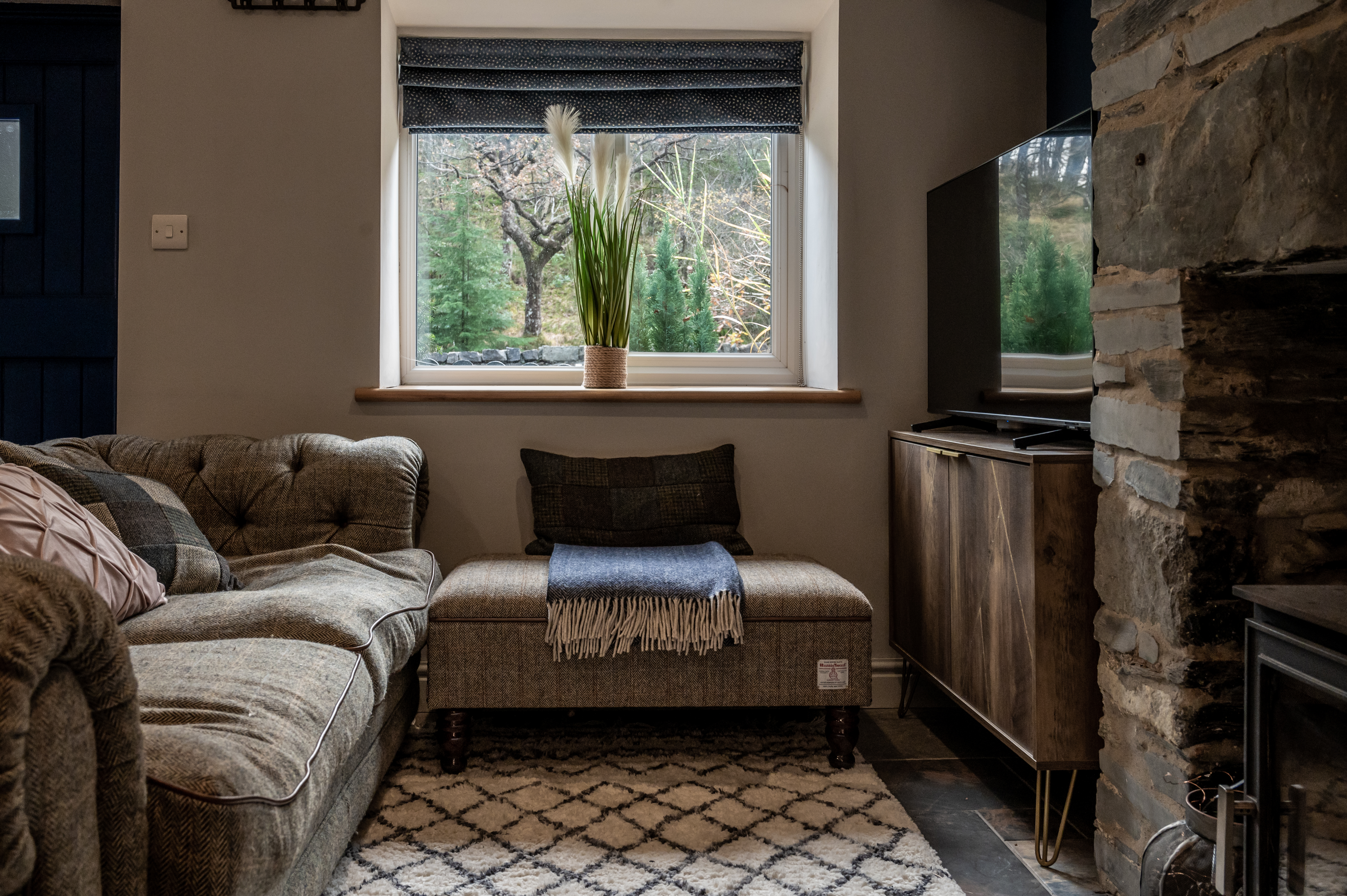 Harris Tweed sofa with wool blankets and window view